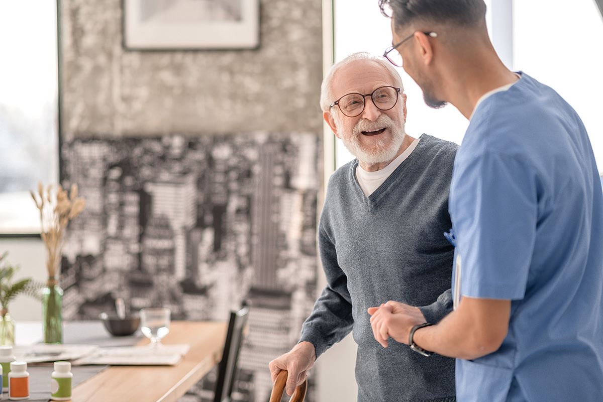 A Home Health Aide assists a patient in their home